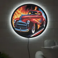 Vintage hotrod racing through fiery landscape LED sign