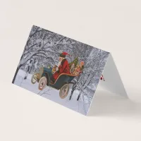 Vintage Santa Driving in a Modern Snow Scene Cards