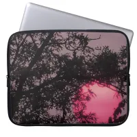 Pretty Pink Sun at Sunset  behind Trees Laptop Sleeve