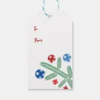 Christmas tree branch with snowflake decorations gift tags