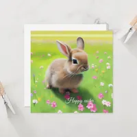 Cute baby rabbit in a flower meadow 