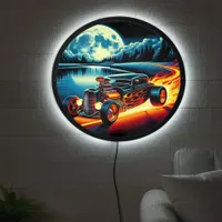 Hotrod racing through a moonlit lakeside road LED sign