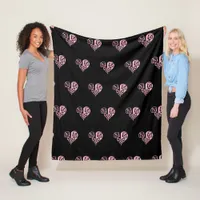 A bold black and pink filigree heart design fleece blanket