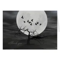 Spooky Ravens Flying Against the Full Moon