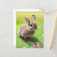 Cute baby rabbit in a flower meadow postcard