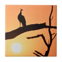 Sunset Majesty: Peacock Silhouette Ceramic Tile