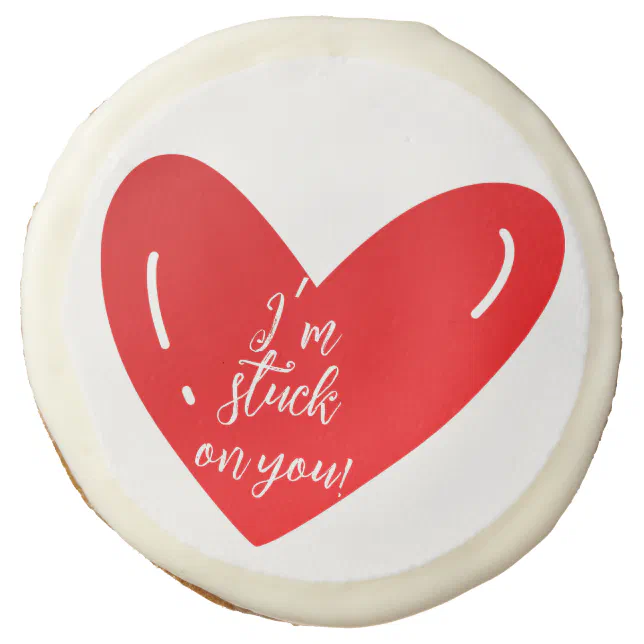 I’m stuck on you message on a red heart shape sugar cookie