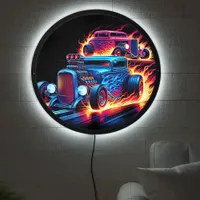 Hot rods racing through a fiery landscape at dusk LED sign