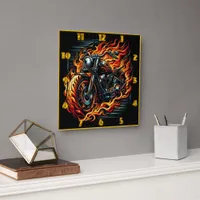 Motorcycle racing through flames at dusk square wall clock