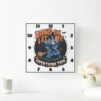 Witch flying over a spooky pumpkin patch at dusk square wall clock