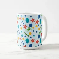 Ocean beach with starfish, shells and pebbles coffee mug