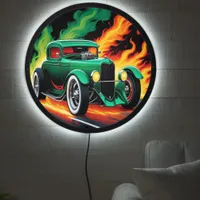 Green hotrod racing through fiery streets at night LED sign