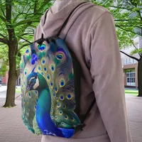 Gorgeous peacock with teal and gold plumage drawstring bag