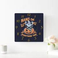 A playful ghost overthinking by a carved pumpkin square wall clock