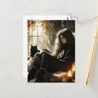 A witch reading with her black cat in a cozy chair postcard