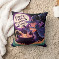 A witch brews potions under a full moon throw pillow