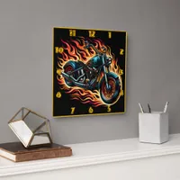 Fiery motorcycle roaring through flames at sunset square wall clock