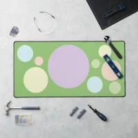 Pastel circles on a green background | desk mat