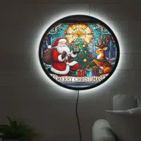 Santa gifts joy to a reindeer by a Christmas tree LED Sign