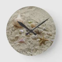 Seashells Nestled in Beach Sand Round Clock