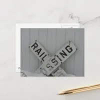 Snowy Rail Crossing Sign in Front of White Barn Postcard