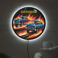 Classic hot rods racing through flames at sunset LED sign