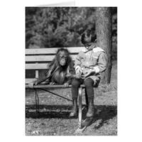 Boy seated with orangutan at the National Zoo