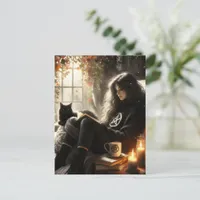 A witch reads with her black cat in a cozy chair postcard