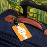 White band oval shield orange monogram luggage tag