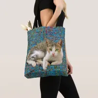 Cute cat on abstract background tote bag