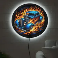 Hotrod blazing through fiery streets at night LED sign