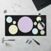 Pastel circles on a black background | desk mat