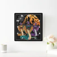 Halloween snakes in vibrant costumes at night square wall clock